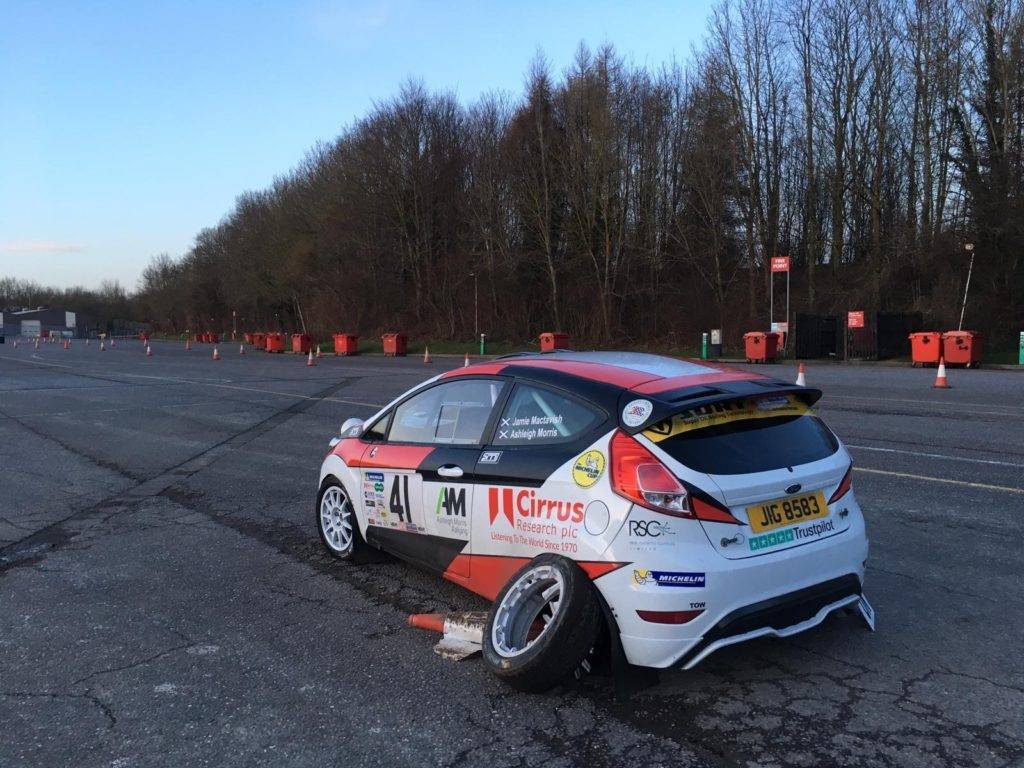 Ashleigh Morris' car on the track after a crash caused significant damage, especially to the back left wheel, causing her to forfeit the rally.